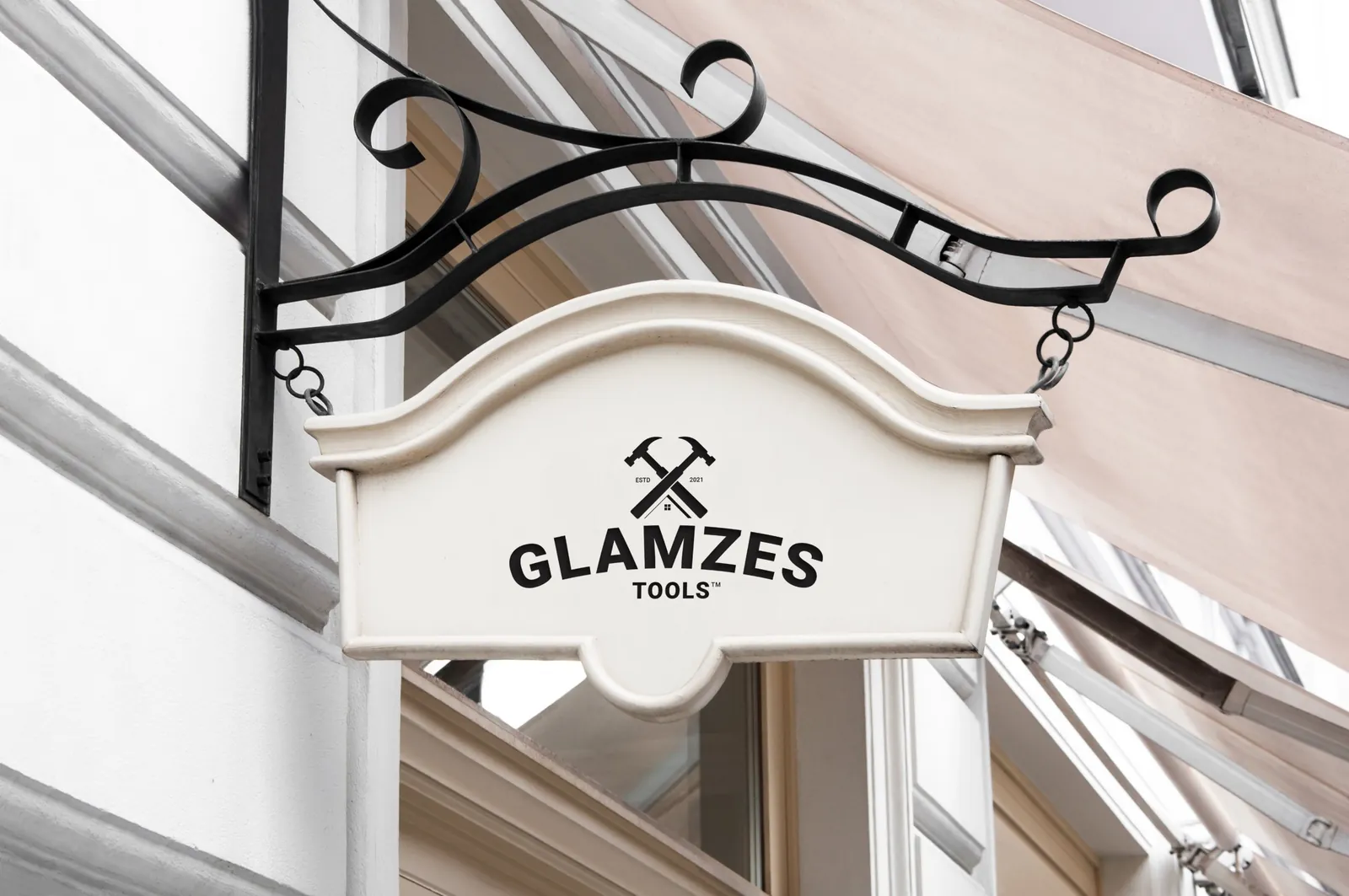 Glamzes Tools logo with crossed hammers on a cream hanging shop sign
